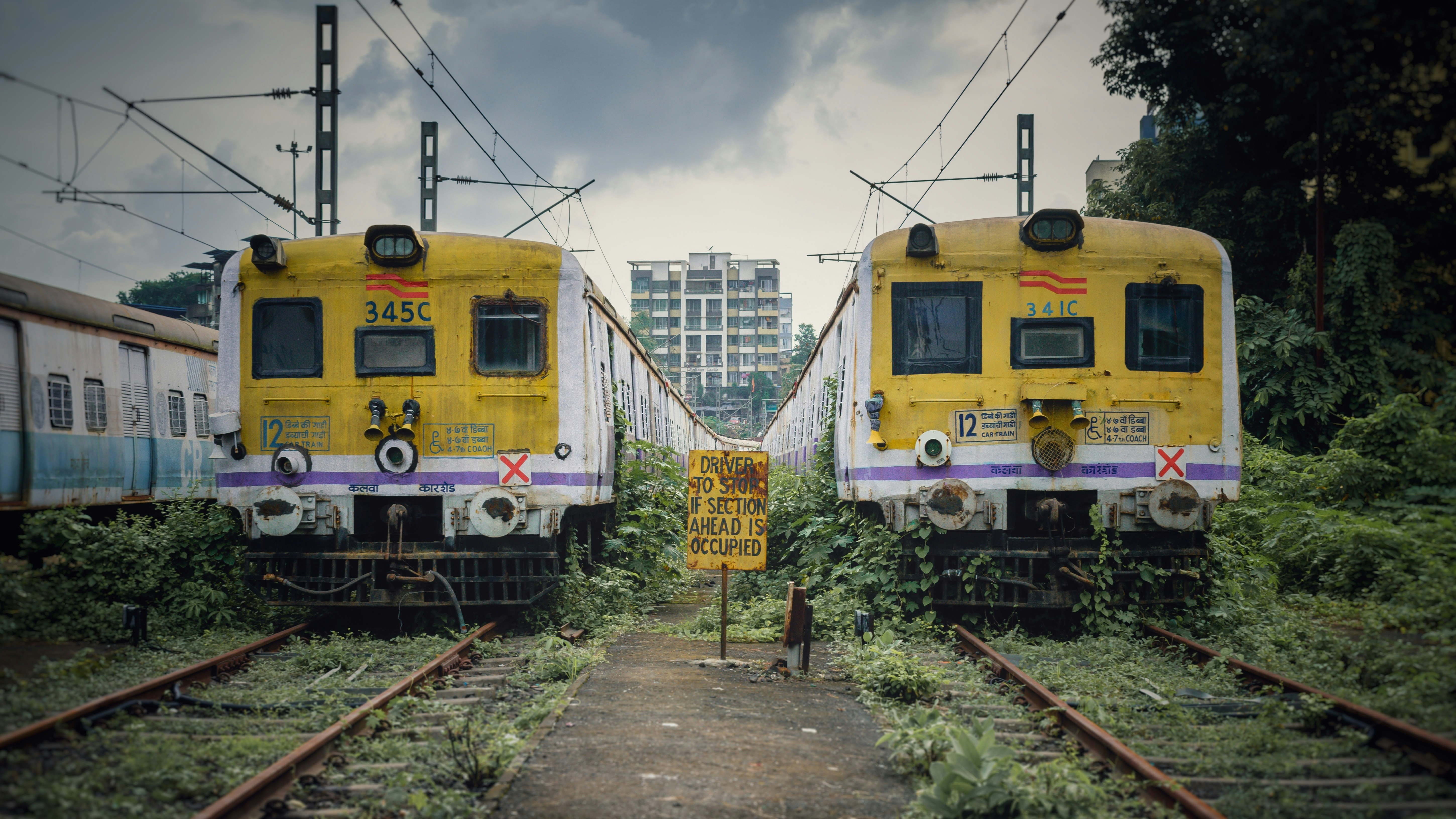 yellow train on rail tracks